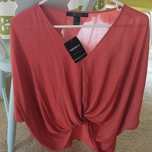 NWT pumpkin colored top Size S.
